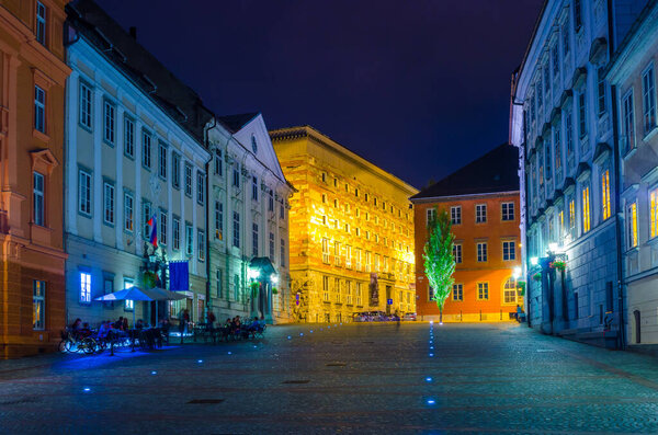 LJUBLJANA, SLOVENIA, JULY 29, 2015: night view of the illuminated novi trg square in the slovenian capital ljubljana where is situated the university library designed by joze plecnik