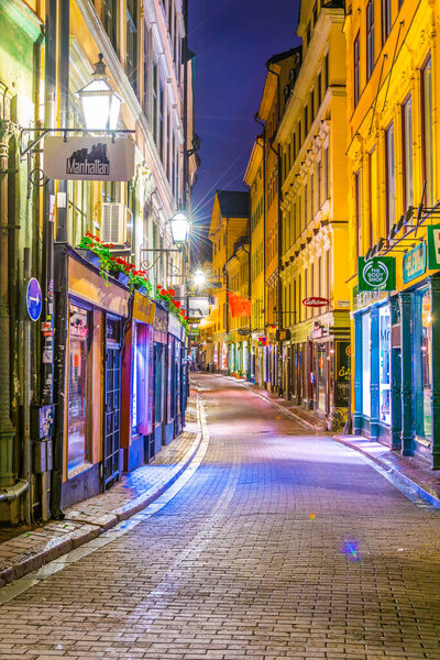 STOCKHOLM, SWEDEN, AUGUST 18, 2016: Night view of an illuminated street in Gamla Stan in central Stockholm, Sweden.