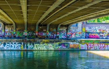 VIENNA, AUSTRIA, JUNE 22, 2015: Graffiti under Marienbruecke , a bridge over Danube Canal (Donaukanal). The embankment walls of Danube Canal form a giant canvas for street artists.