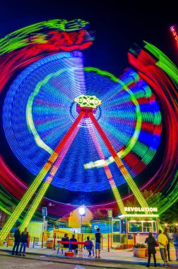 VIENNA, AUSTRIA, JUNE 2016: Night shot of the illuminated prater amusement park in Vienna which captures light trail of an attraction