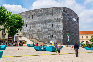 VIENNA, AUSTRIA, JUNE, 2016: Young people are chilling out on benches in front of the Mumok museum situated in the museumsquartier district in Vienna.