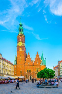 WROCLAW, POLAND, MAY 28, 2017: People are passing beautiful town hall at Rynek, the picturesque square in central Wroclaw, Poland