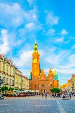 WROCLAW, POLAND, MAY 28, 2017: People are passing beautiful town hall at Rynek, the picturesque square in central Wroclaw, Poland