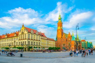 WROCLAW, POLAND, MAY 28, 2017: People are passing beautiful town hall at Rynek, the picturesque square in central Wroclaw, Poland