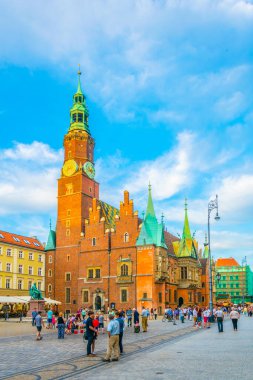 WROCLAW, POLAND, MAY 28, 2017: People are passing beautiful town hall at Rynek, the picturesque square in central Wroclaw, Poland