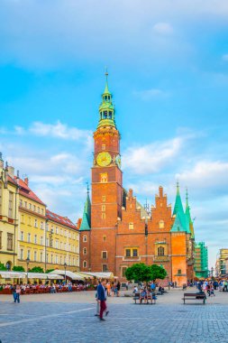 WROCLAW, POLAND, MAY 28, 2017: People are passing beautiful town hall at Rynek, the picturesque square in central Wroclaw, Poland