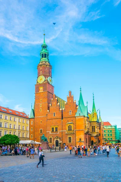 WROCLAW, POLAND, MAY 28, 2017: People are passing beautiful town hall at Rynek, the picturesque square in central Wroclaw, Poland