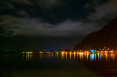 Night panoramic view of the illuminated zell am see town in Austria.