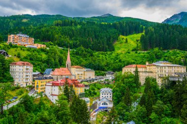 Austrian ski and spa resort Bad Gastein dominated by a parish church and a waterwall flowing through ist city center.