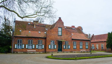 view of small brick houses situated inside of the new garden park in potsdam.