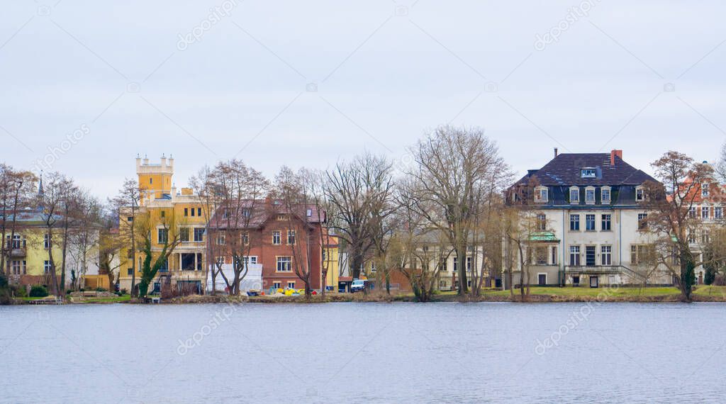 view of villas situated on the shore of heiliger see in potsdam, germany.