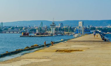 İnsanlar Bulgaristan 'daki Varna limanının rıhtımında güneşli bir günün tadını çıkarıyorlar.