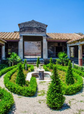 small green courtyard inside of the ruins of pompeii city complex near italian naples. clipart