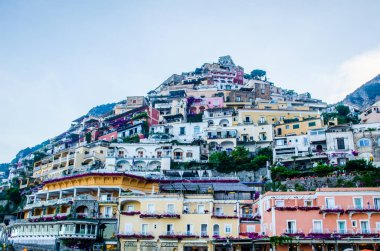 view of italian city positano situated on amalfi coast during summer sunset