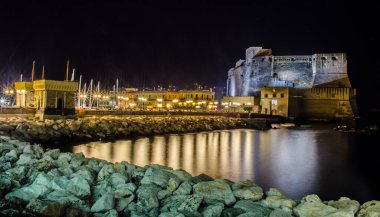 night view of illuminated Castel dell'Ovo (Egg Castle) a medieval fortress in the bay of Naples, Italy
