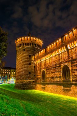 night view of the illuminated castello sforzesco in milano.