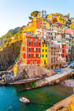 Riomaggiore village lit during sunset in Cinque terre, Italy.