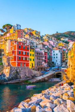 Riomaggiore village lit during sunset in Cinque terre, Italy.