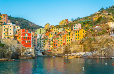 Riomaggiore village lit during sunset in Cinque terre, Italy.