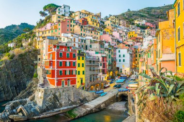 Riomaggiore village lit during sunset in Cinque terre, Italy.