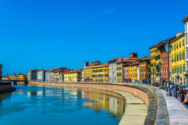 İtalyan şehri Pisa 'nın tarihi merkezinde Arno nehri boyunca uzanan tarihi binalar..