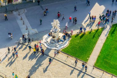aerial view of people enjoying sunny day on the piazza die miracoli in Pisa where is the famous leaning tower situated.