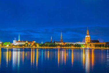 Sunset view of the Riga cathedral, cathedral and saint James church from the other side of the Daugava river, Latvia