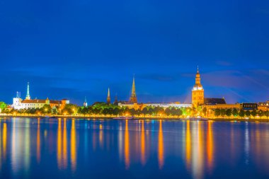 Sunset view of the Riga cathedral, cathedral and saint James church from the other side of the Daugava river, Latvia