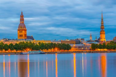 Sunset view of the Riga cathedral and saint James church from the other side of the Daugava river, Latvia