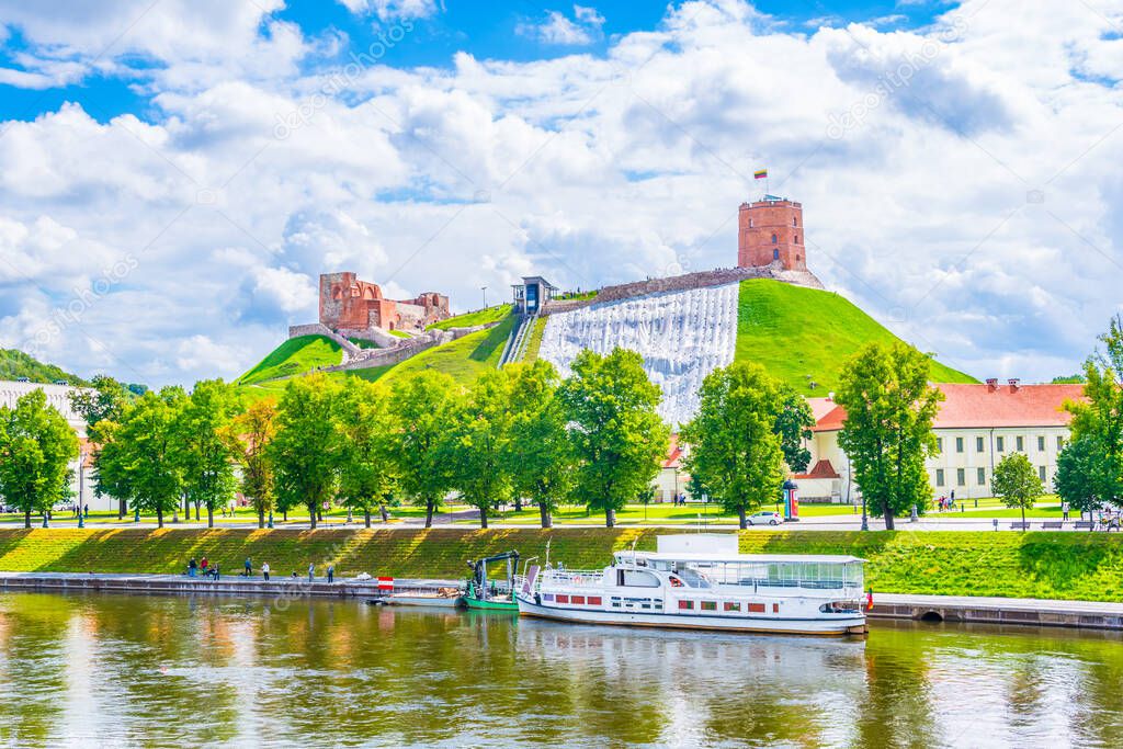 Gediminas castle in the lithuanian capital Vilnus reflecting on the river Neris