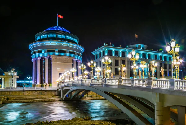 stock image night view of the bridge leading towards the Ministry of Foreign Affairs and the Financial Police in skopje which is decorated by many statues related to history of macedonia, fyrom.