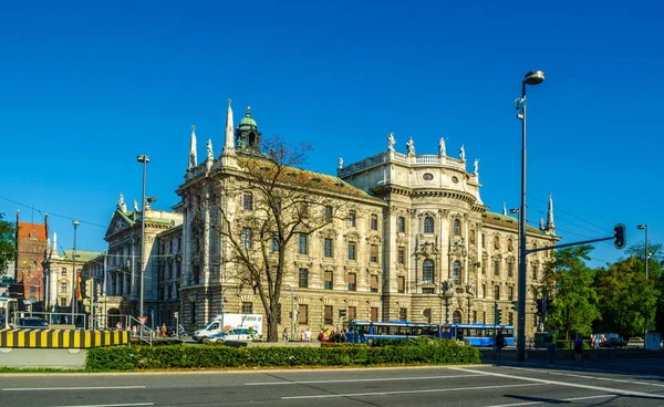 View of langericht court in german city munich hidden behind magnificent fountain.