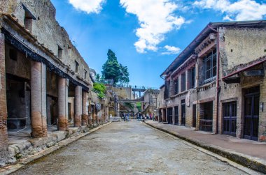 ruins of herculaneum destroyed by vesuvius volcano are less famous than ruins of pompeii, but nevertheless they also create compact area of former buildings attracting thousands of tourist every year clipart