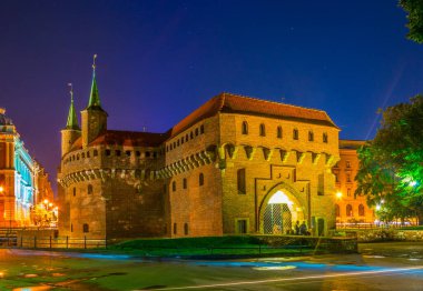 Night view of the Barbikan gate situated in the Polish city Krakow.