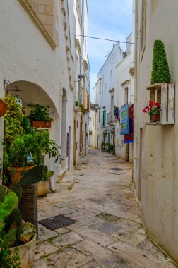 View of a white narrow street in the Italian city Locorotond