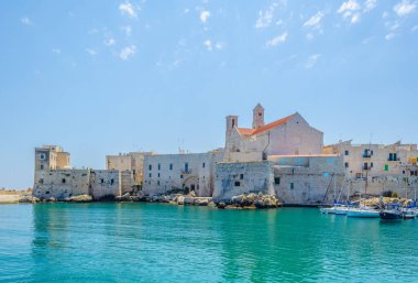 Giovinazzo limanının manzarası İtalya 'daki yerel katedralin görkemli binasının egemenliğinde.