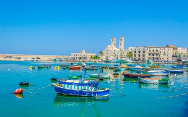 View of the port of Molfetta dominated by a majestic building of the local cathedral Duomo vecchio di san Corrado in Italy