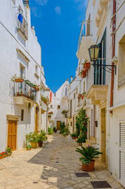 View of a white narrow street in the Italian city Locorotond