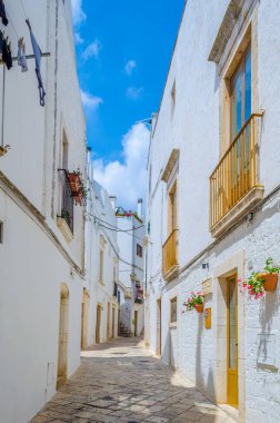 View of a white narrow street in the Italian city Locorotond
