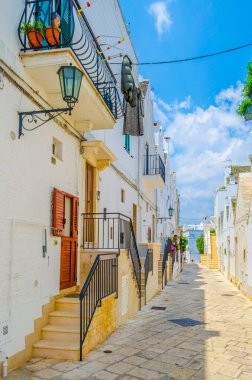 View of a white narrow street in the Italian city Locorotond