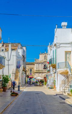 View of a white narrow street in the Italian city Cisternin