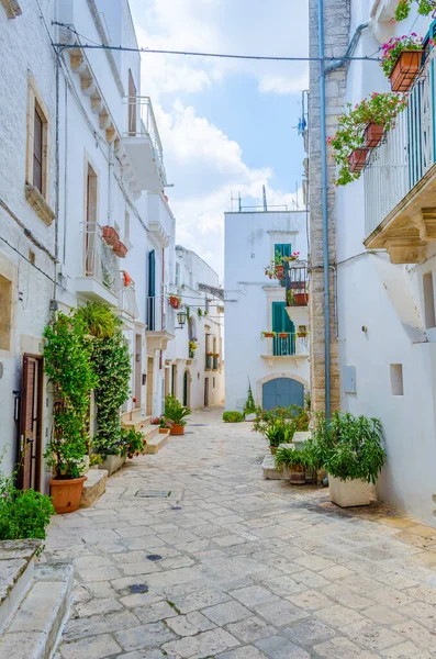 View of a white narrow street in the Italian city Locorotond