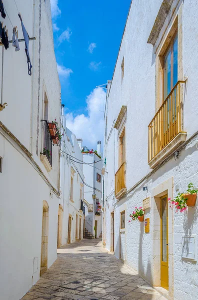 View of a white narrow street in the Italian city Locorotond