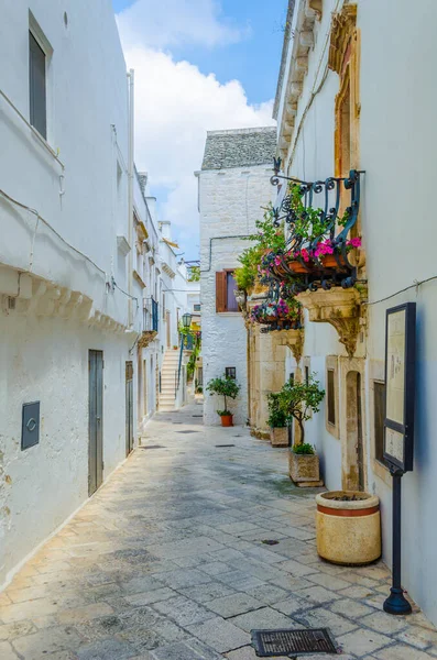 View of a white narrow street in the Italian city Locorotond