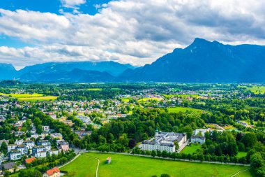 Avusturya 'nın Salzburg kentinde bir banliyö manzarası. Aile evleri ormanlar, çayırlar ve tepelerle çevrili.