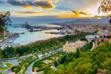 aerial view of malaga taken from gibralfaro castle including port of malaga, alcazaba castle and the cathedral of malaga during sunset clipart