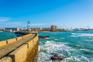 İspanyol şehri Cadiz 'deki San Sebastian şatosuna giden dar bir tuğla yol.