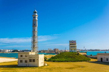 view of a lighthouse situated inside of the castle of san sebastian in cadiz, spain