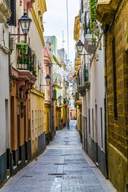 a narrow street in historical center of spanish city cadiz