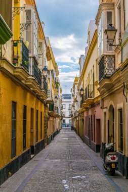 a narrow street in historical center of spanish city cadiz